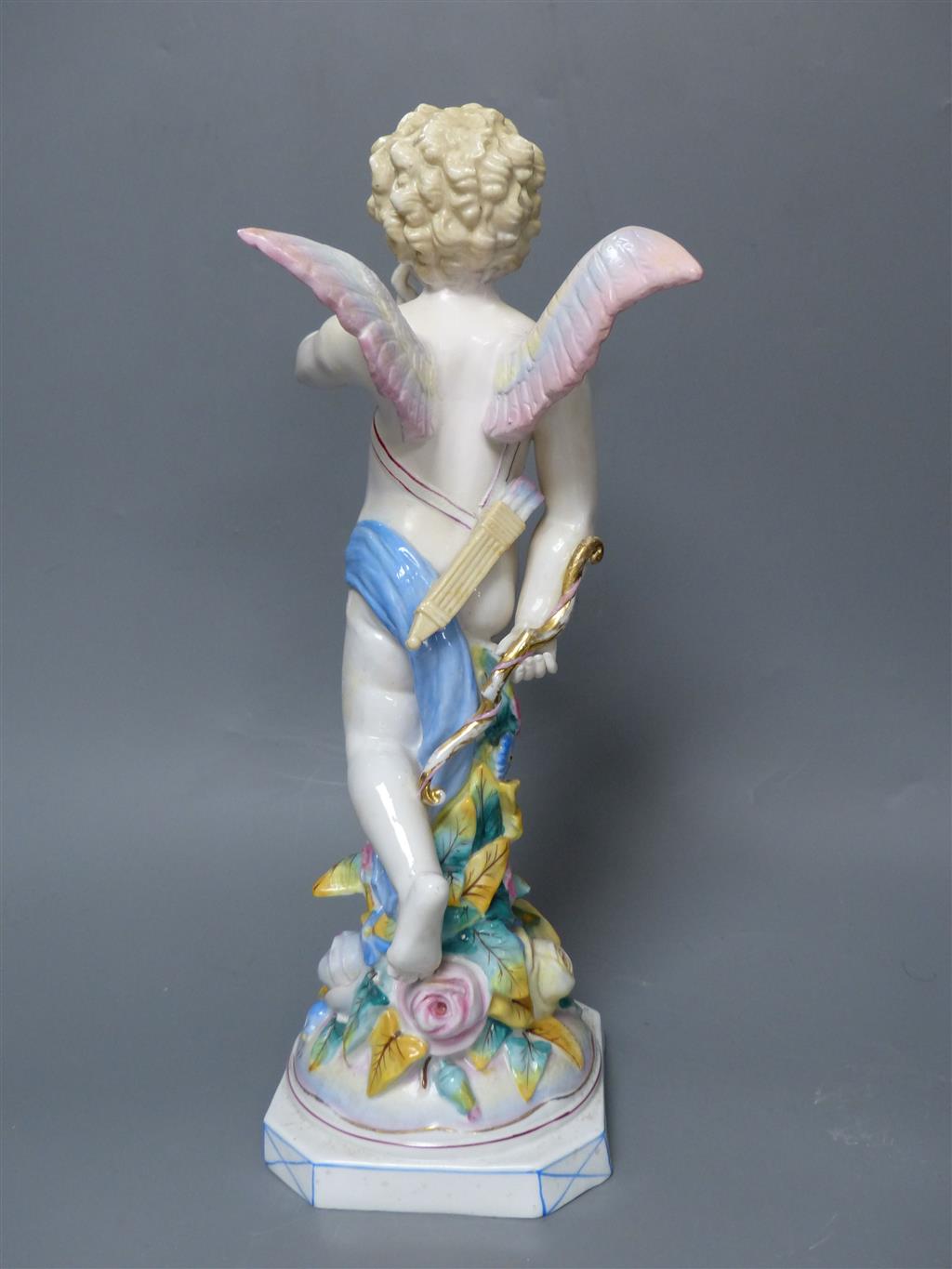 A large late 19th century French porcelain figure of Cupid, an English bone china cherub vase and a similar sweetmeat dish, tallest 3